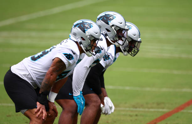 (L-R) Jackson Mitchell #49, Trevin Wallace #56, and Michael Barrett #41 of the Carolina Panthers