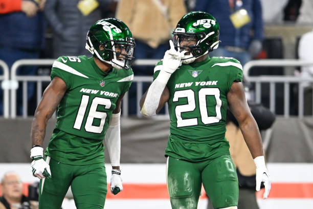 Breece Hall #20 and Jason Brownlee #16 of the New York Jets