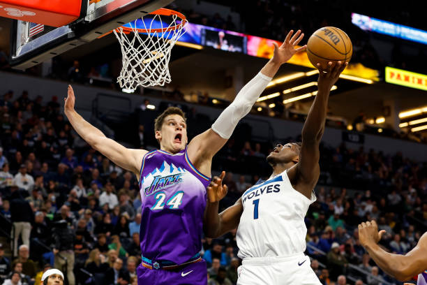 Anthony Edwards #1 of the Minnesota Timberwolves goes up for a shot while Walker Kessler #24 of the Utah Jazz defends